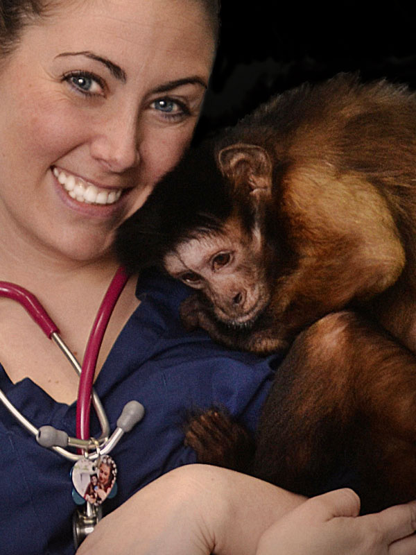 Helping Hands Monkey Helpers veterinary staff holding monkey