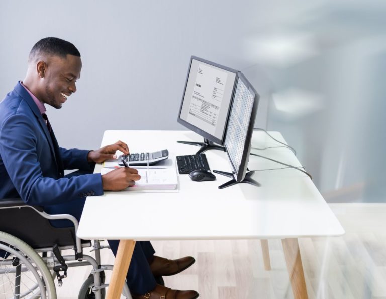 Man at a computer in a wheelchair