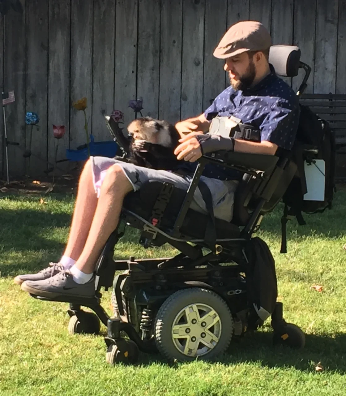 A man in a wheelchair with a monkey